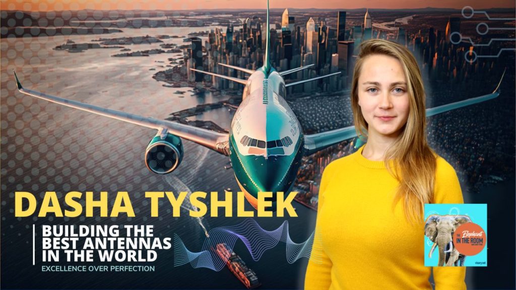 Image of Dasha Tyshlek in a yellow shirt in front of an airplane background. Graphic reads "Dasha Tyshlek" Building the Best Antennas in the world. Excellence over perfection.